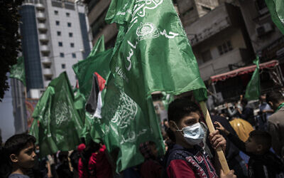 Palestinians holding Hamas movement green flags attend a protest in solidarity with Muslim worshipers in Jerusalem, in Gaza City, April 23, 2021. (AP Photo/Khalil Hamra)
