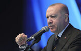 In this March 24, 2021, file photo, Turkey's President Recep Tayyip Erdogan gestures as he speaks during his ruling party's congress inside a packed sports hall in Ankara, Turkey. (Turkish Presidency via AP, File)