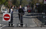 French police officers block the access next to the police station where a police official was stabbed to death Friday in Rambouillet, south west of Paris, Saturday, April 24, 2021. (AP Photo/Michel Euler)