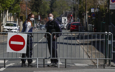 French police officers block the access next to the police station where a police official was stabbed to death Friday in Rambouillet, south west of Paris, Saturday, April 24, 2021. (AP Photo/Michel Euler)