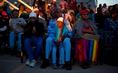 In this Sunday, May 26, 2013 file photo, members of the Black Hebrews community attend the Shavuot harvest festival in their Village of Peace in the town of Dimona, southern Israel. The African Hebrew Israelites of Jerusalem, as they call themselves, a community of black Americans who left the United States for Israel, believe they are the lost tribe of Judah, exiled from the Holy Land by the Romans in 70 A.D. According to their teachings, their ancestors wandered across North Africa and eventually settled in West Africa, where they were later captured and sold into slavery in the New World. (AP Photo/Ariel Schalit)