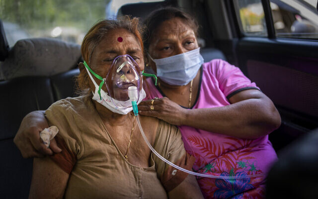FILE - In this April 24, 2021, file photo, a COVID-19 patient inside a car, receives oxygen provided by a Gurdwara, a Sikh house of worship, in New Delhi, India. India’s death toll from COVID-19 has surpassed 200,000 people as a surge has wept the country in recent weeks, a rise rooted in various so-called super-spreader events that were allowed to happen in the months following the autumn when the country had seemingly brought the pandemic under control. (AP Photo/Altaf Qadri, File) FILE - In this April 24, 2021, file photo, a COVID-19 patient inside a car, receives oxygen provided by a Gurdwara, a Sikh house of worship, in New Delhi, India. India’s death toll from COVID-19 has surpassed 200,000 people as a surge has wept the country in recent weeks, a rise rooted in various so-called super-spreader events that were allowed to happen in the months following the autumn when the country had seemingly brought the pandemic under control. (AP Photo/Altaf Qadri, File)