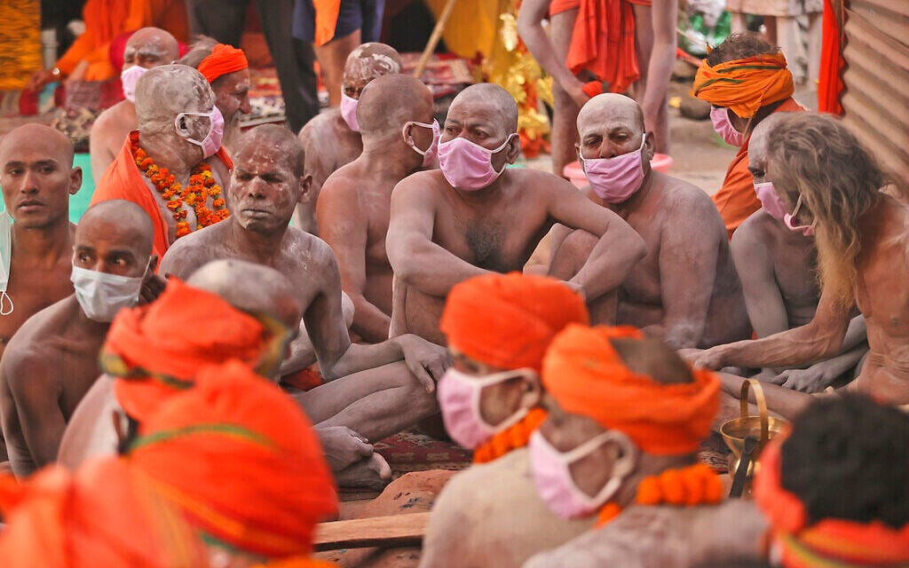 Naga Sadhu, naked Hindu holy men, wait for the start of a procession towards the river Ganges for Shahi Snan (Royal Bath) during Kumbh Mela, in Haridwar in the Indian state of Uttarakhand, Monday, April 12, 2021. As states across India are declaring some version of a lockdown to battle rising COVID-19 cases in a nationwide second-wave, thousands of pilgrims are gathering on the banks of the river Ganges for the Hindu festival. The faithful believe that a dip in the waters of the Ganges will absolve them of their sins and deliver them from the cycle of birth and death. (AP Photo/Karma Sonam) Naga Sadhu, naked Hindu holy men, wait for the start of a procession towards the river Ganges for Shahi Snan (Royal Bath) during Kumbh Mela, in Haridwar in the Indian state of Uttarakhand, Monday, April 12, 2021. As states across India are declaring some version of a lockdown to battle rising COVID-19 cases in a nationwide second-wave, thousands of pilgrims are gathering on the banks of the river Ganges for the Hindu festival. The faithful believe that a dip in the waters of the Ganges will absolve them of their sins and deliver them from the cycle of birth and death. (AP Photo/Karma Sonam)