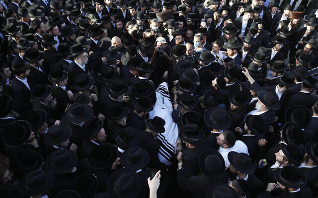 Mourners carry the body of Shraga Gestetner, a Canadian singer who died during Lag BaOmer celebrations at Mt. Meron in northern Israel, at his funeral in Jerusalem on Friday, April 30, 2021.  (AP Photo/Ariel Schalit)