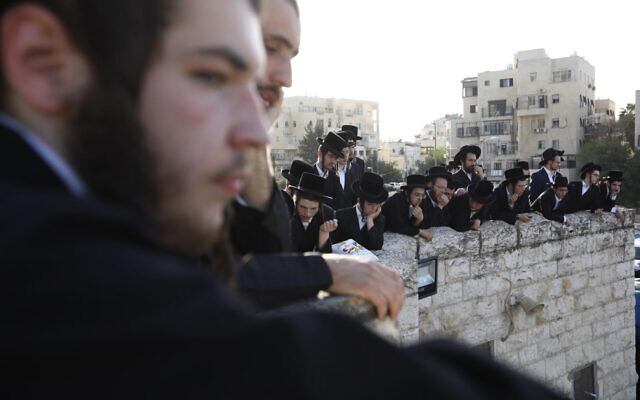 Ultra-Orthodox men watch the funeral of Shraga Gestetner, a Canadian singer who died during Lag B'Omer celebrations at Mt. Meron in northern Israel, in Jerusalem on Friday, April 30, 2021. (AP Photo/Ariel Schalit) Ultra-Orthodox men watch the funeral of Shraga Gestetner, a Canadian singer who died during Lag B'Omer celebrations at Mt. Meron in northern Israel, in Jerusalem on Friday, April 30, 2021. (AP Photo/Ariel Schalit)
