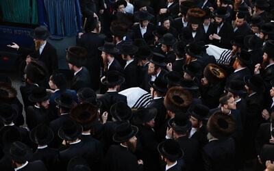 Ultra-Orthodox men carry the bodies of Moshe Englard, 14, and his brother, Yehoshua, 9, who died during Lag B'Omer celebrations at Mt. Meron in northern Israel, in Jerusalem on Friday, April 30, 2021. (AP Photo/Ariel Schalit)