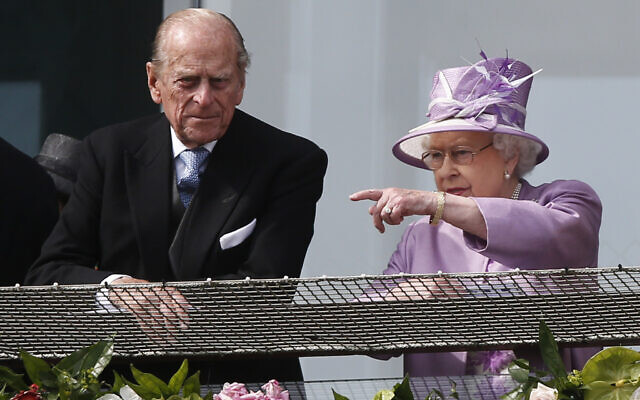 Britain's Queen Elizabeth II points out something to Prince Philip as they watch the Epsom Derby from the balcony at Epsom racecourse, England, June 7, 2014. (AP Photo/Sang Tan) Britain's Queen Elizabeth II points out something to Prince Philip as they watch the Epsom Derby from the balcony at Epsom racecourse, England, June 7, 2014. (AP Photo/Sang Tan)