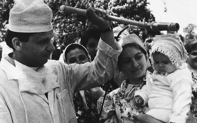A Soviet medical technician checks an unidentified child one of the evacuees from the Chernobyl nuclear power plant accident moved to the Kopelovo State Farm in the Ukraine near Kiev, May 11, 1986. This picture was made by a visiting photographed on a trip organized by Soviet officials to show how they are dealing with the accident. (AP Photo/Boris Yurchenko)