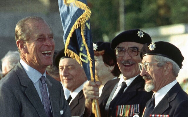 Britain’s Prince Philip jokes with British WWII veterans Nathan Kohaen, right, and Arthur Stark, who immigrated to Israel, during a ceremony at the Commonwealth War Cemetery in Ramle, Israel, on Oct. 30, 1994, where he came to lay a wreath (AP Photo)