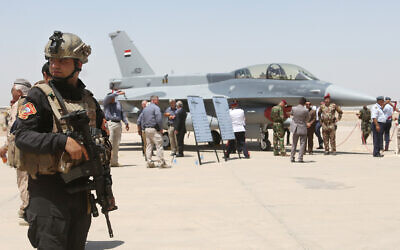 FILE: A member of the Iraqi SWAT team stands guard as security forces and others gather next to a US-made F-16 fighter jet during the delivery ceremony at Balad air base, Iraq, July 20, 2015. (AP Photo/Khalid Mohammed, File)