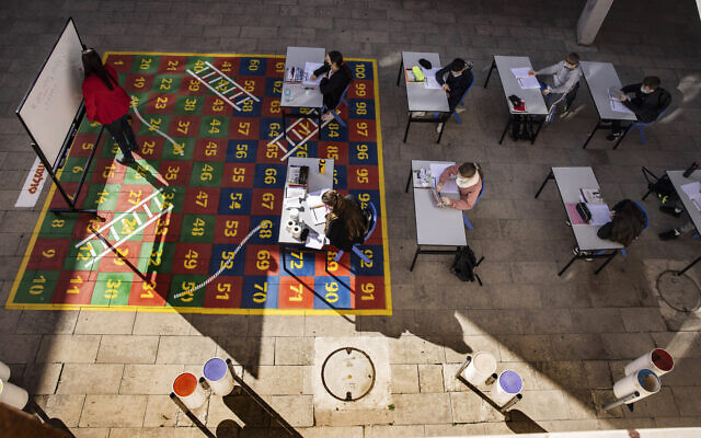 Students take part in a lesson in their makeshift outdoor classroom in the coastal city of Ashkelon, February 11, 2021. (AP Photo/Tsafrir Abayov) Students take part in a lesson in their makeshift outdoor classroom in the coastal city of Ashkelon, February 11, 2021. (AP Photo/Tsafrir Abayov)