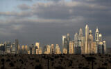 Illustrative: The sunrise reflects on city skylines at the Marina and Jumeirah Lake Towers districts in Dubai, United Arab Emirates, Feb. 27, 2021. (AP Photo/Kamran Jebreili)