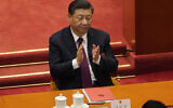 Chinese President Xi Jinping applauds during the closing session of the National People's Congress in Beijing on Thursday, on March 11, 2021. (AP Photo/Sam McNeil)