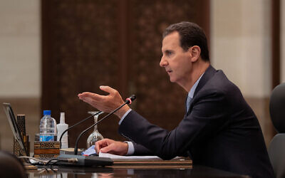 Syrian President Bashar Assad heads a cabinet meeting, in Damascus, Syria, March 30, 2021. (Syrian Presidency Facebook page via AP)