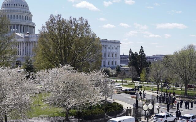 Police officers surround the scene after a car that crashed into a barrier on Capitol Hill on the Senate side of the US Capitol in Washington, Friday, April 2, 2021. (AP Photo/J. Scott Applewhite) Police officers surround the scene after a car that crashed into a barrier on Capitol Hill on the Senate side of the US Capitol in Washington, Friday, April 2, 2021. (AP Photo/J. Scott Applewhite)