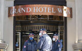 Police officers stay in front of the 'Grand Hotel Wien' in Vienna, Austria, April 9, 2021, where closed-door nuclear talks with Iran take place. (AP Photo/Florian Schroetter)