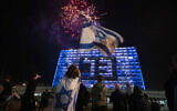 Israelis watch a fireworks show during Israel's Independence Day celebrations after more than a year of coronavirus restrictions in Tel Aviv, Israel, Wednesday, April 14, 2021. (AP Photo/Sebastian Scheiner)