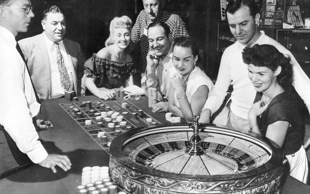 People are shown at one of the gaming tables at the Flamingo Casino in Las Vegas, Nevada, May 24, 1955.  (AP Photo)