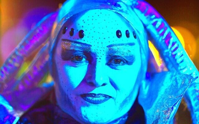 In this February 14, 2016 illustrative photo, a woman in an alien costume poses for a picture during the annual Alien Festival in Capilla del Monte, Cordoba, Argentina, the site of an alleged UFO sighting 30 years ago. (AP Photo/Natacha Pisarenko)