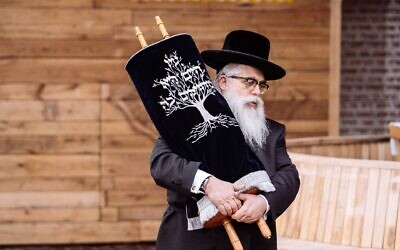 Ukrainian Chief Rabbi Yaakov Dov Bleich holds a Torah scroll during the opening ceremony of the Babyn Yar synagogue in Kyiv, April 7, 2021. (Babyn Yar Holocaust Memorial Center)