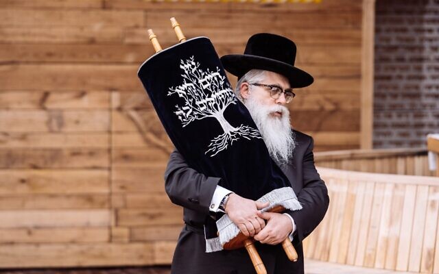 Ukrainian Chief Rabbi Yaakov Dov Bleich holds a Torah scroll during the opening ceremony of the Babyn Yar synagogue in Kyiv, April 7, 2021. (Babyn Yar Holocaust Memorial Center) Ukrainian Chief Rabbi Yaakov Dov Bleich holds a Torah scroll during the opening ceremony of the Babyn Yar synagogue in Kyiv, April 7, 2021. (Babyn Yar Holocaust Memorial Center)