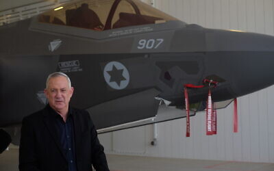 Defense Minister Benny Gantz stands in front of an F-35 fighter jet at the Nevatim air base on April 12, 2021. (Judah Ari Gross/Times of Israel)