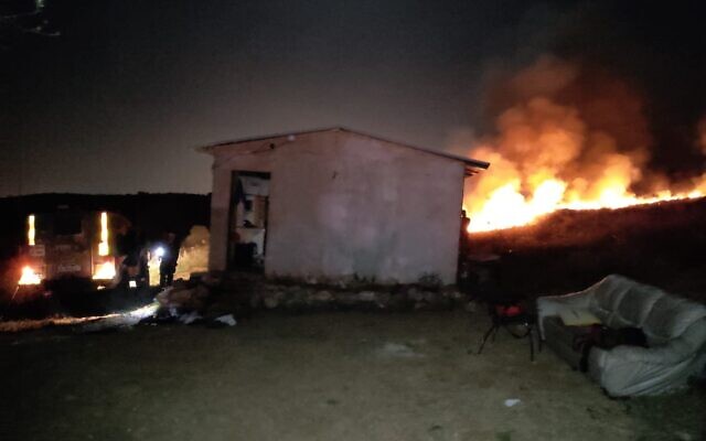 A fire rages outside a cabin in the illegal Oz Zion outpost in the central West Bank after it was firebombed on April 29, 2021. (Courtesy) A fire rages outside a cabin in the illegal Oz Zion outpost in the central West Bank after it was firebombed on April 29, 2021. (Courtesy)