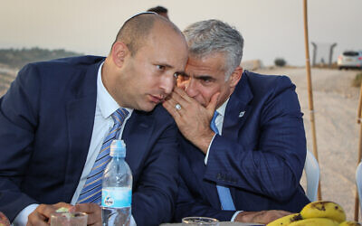Then-education minister Naftali Bennett (L) and Yesh Atid chairman Yair Lapid during a ceremony at Netiv Ha'avot, at the West Bank's Elazar settlement, on July 23, 2017. (Gershon Elinson/Flash90)