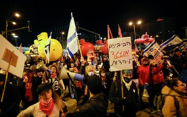 Illustrative: Israelis march in protest against then-prime minister Benjamin Netanyahu, at the entrance to Jerusalem, on January 30, 2021. (Olivier Fitoussi/Flash90) Illustrative: Israelis march in protest against then-prime minister Benjamin Netanyahu, at the entrance to Jerusalem, on January 30, 2021. (Olivier Fitoussi/Flash90)