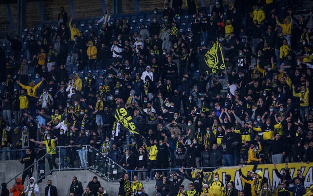 Soccer fans at a game between Beitar Jerusalem FC and Ashdod FC, at Teddy Stadium, in Jerusalem, on March 17, 2021. (Flash90) Soccer fans at a game between Beitar Jerusalem FC and Ashdod FC, at Teddy Stadium, in Jerusalem, on March 17, 2021. (Flash90)