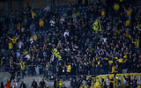 Beitar Jerusalem fans cheer during the State Cup match between Beitar Jerusalem F.C. and Ashdod F.C. in the Teddy stadium, Jerusalem, on March 17, 2021. (Flash90)