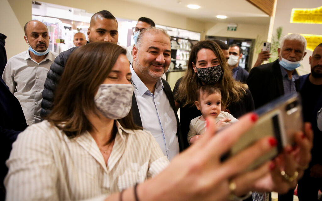 Ra'am party leader Mansour Abbas with supporters at a press conference in Nazareth, April 1, 2021. (David Cohen/Flash90) Ra'am party leader Mansour Abbas with supporters at a press conference in Nazareth, April 1, 2021. (David Cohen/Flash90)