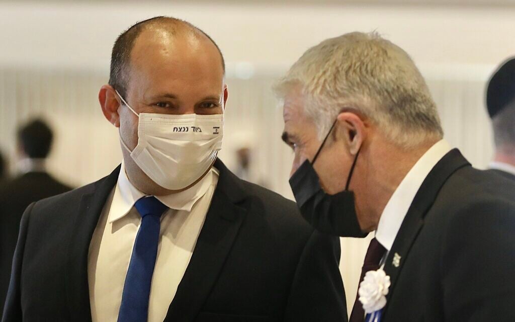 Yamina party leader Naftali Bennett (left) and Yesh Atid leader Yair Lapid during the swearing-in ceremony of the 24th Knesset, at the Knesset building in Jerusalem, April 6, 2021. (Marc Israel Sellem/Pool) Yamina party leader Naftali Bennett (left) and Yesh Atid leader Yair Lapid during the swearing-in ceremony of the 24th Knesset, at the Knesset building in Jerusalem, April 6, 2021. (Marc Israel Sellem/Pool)