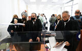Court official prepare for the second day of the evidentiary stage of the corruption trial of Prime Minister Benjamin Netanyahu at the Jerusalem District Court on April 6, 2021. (Yonatan Sindel/FLASH90)