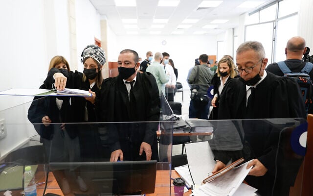 Court official prepare for the second day of the evidentiary stage of the corruption trial of Prime Minister Benjamin Netanyahu at the Jerusalem District Court on April 6, 2021. (Yonatan Sindel/FLASH90) Court official prepare for the second day of the evidentiary stage of the corruption trial of Prime Minister Benjamin Netanyahu at the Jerusalem District Court on April 6, 2021. (Yonatan Sindel/FLASH90)