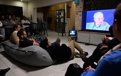 Israelis watch the testimony of a Holocaust survivor during a meeting as part of 'Zikaron Basalon' project, on the eve of the Holocaust Remembrance Day, in Moshav Kidmat Tzvi, April 7, 2021. (Michael Giladi/Flash90)