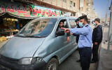 Members of the Palestinian security forces perform checks on the street after a lockdown was ordered in Gaza Strip until April 11, 2021, to curb the spreading of coronavirus. (Abed Rahim Khatib/Flash90