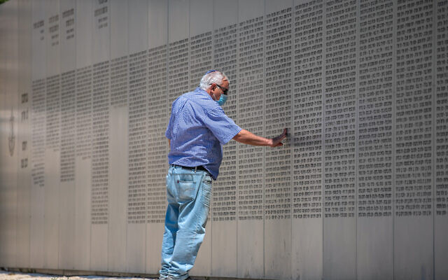 An Israeli man looks at wall with names of fallen soldiers of the armored corps in Latrun's Military memorial, April 13, 2021, ahead of Israeli Memorial Day, which begins tonight. (Yossi Aloni/Flash90) An Israeli man looks at wall with names of fallen soldiers of the armored corps in Latrun's Military memorial, April 13, 2021, ahead of Israeli Memorial Day, which begins tonight. (Yossi Aloni/Flash90)