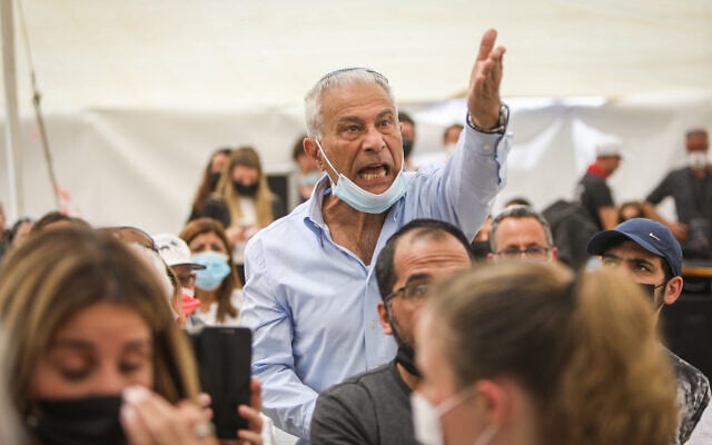 A man reacts during a speech of Prime Minister Benjamin Netanyahu at a state memorial ceremony for victims of terror, at Mount Herzl military cemetery in Jerusalem, April 14, 2021. (Noam Revkin Fenton/Flash90) A man reacts during a speech of Prime Minister Benjamin Netanyahu at a state memorial ceremony for victims of terror, at Mount Herzl military cemetery in Jerusalem, April 14, 2021. (Noam Revkin Fenton/Flash90)