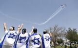 People watch an IDF Air Force flyover on Israel's 73rd Independence Day celebrations at Sacher Park in Jerusalem, April 15, 2021. (Yonatan Sindel/Flash90)