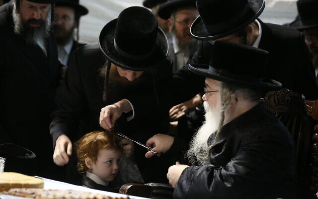 Ultra-Orthodox Jewish boy gets his first haircut at Meron ahead of the Jewish holiday of Lag b'Omer, April 28, 2021 (David Cohen/FLASH90)