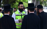 People outside the Institute of Forensic Medicine in Tel Aviv, where victims of Mount Meron crush were brought to be identified, April 30, 2021. (Tomer Neuberg/Flash90)