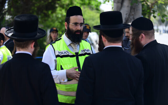 People outside the Institute of Forensic Medicine in Tel Aviv, where victims of Mount Meron crush were brought to be identified, April 30, 2021. (Tomer Neuberg/Flash90) People outside the Institute of Forensic Medicine in Tel Aviv, where victims of Mount Meron crush were brought to be identified, April 30, 2021. (Tomer Neuberg/Flash90)