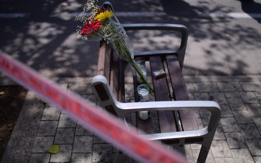 Flowers on a bench outside the Institute of Forensic Medicine in Tel Aviv, where victims of Mount Meron crush were brought to be identified, April 30, 2021. (Tomer Neuberg/Flash90)