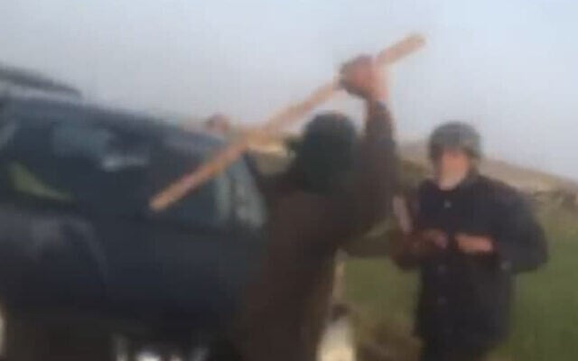 A settler beats Arik Ascherman with a wooden bat on April 7, 2021 in the West Bank, near Ma'ale Ahuvia. (Screenshot: Gil Hammerschlag/ Twitter) A settler beats Arik Ascherman with a wooden bat on April 7, 2021 in the West Bank, near Ma'ale Ahuvia. (Screenshot: Gil Hammerschlag/ Twitter)