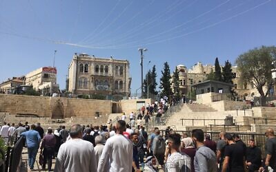 Palestinians leaving Jerusalem's Old City outside Damascus Gate following noon prayers on Friday, April 16, 2021 (Aaron Boxerman/The Times of Israel)