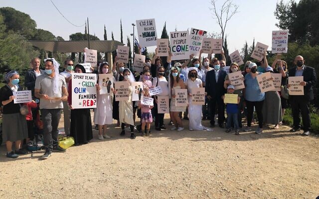 Demonstrators gathered in the Rose Garden across from the Knesset to protest the government’s lack of policy regarding entry permits for family members to enter Israel, March 6, 2021. (Jessica Steinberg/Times of Israel) Demonstrators gathered in the Rose Garden across from the Knesset to protest the government’s lack of policy regarding entry permits for family members to enter Israel, March 6, 2021. (Jessica Steinberg/Times of Israel)