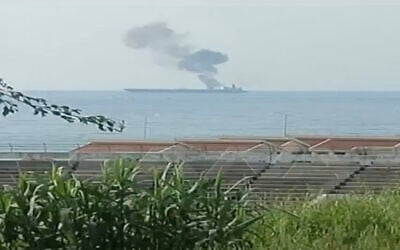 A screenshot of video aired by Syrian state TV on April 24, 2021, shows a fire on a ship off the coast of Banyas, which Syria says was apparently started after the ship was attacked by a drone. (Screen capture: Twitter)