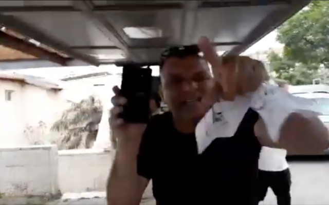 A pro-Netanyahu supporter who verbally attacked Maria Elkin, wife of New Hope MK Ze'ev Elkin, outside their Jerusalem home on April 19, 2021. (Screen capture: Twitter) A pro-Netanyahu supporter who verbally attacked Maria Elkin, wife of New Hope MK Ze'ev Elkin, outside their Jerusalem home on April 19, 2021. (Screen capture: Twitter)