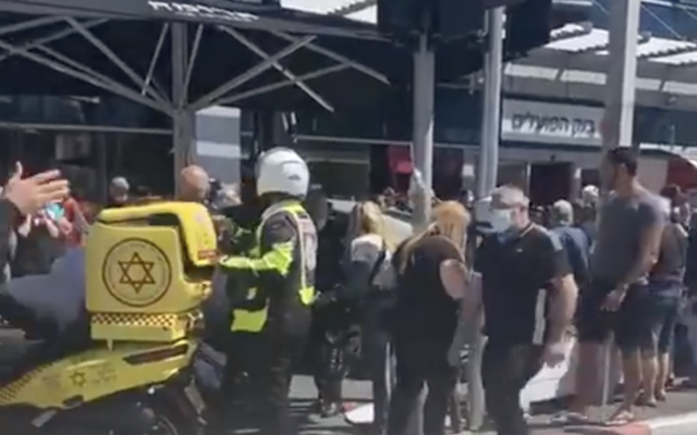 A crowd of people and MDA medics gather around Aroma cafe in Bat Yam, where a car crashed into the pavement, injuring 15 customers, on April 22, 2021. (Screen capture: Twitter/ Army Radio) A crowd of people and MDA medics gather around Aroma cafe in Bat Yam, where a car crashed into the pavement, injuring 15 customers, on April 22, 2021. (Screen capture: Twitter/ Army Radio)
